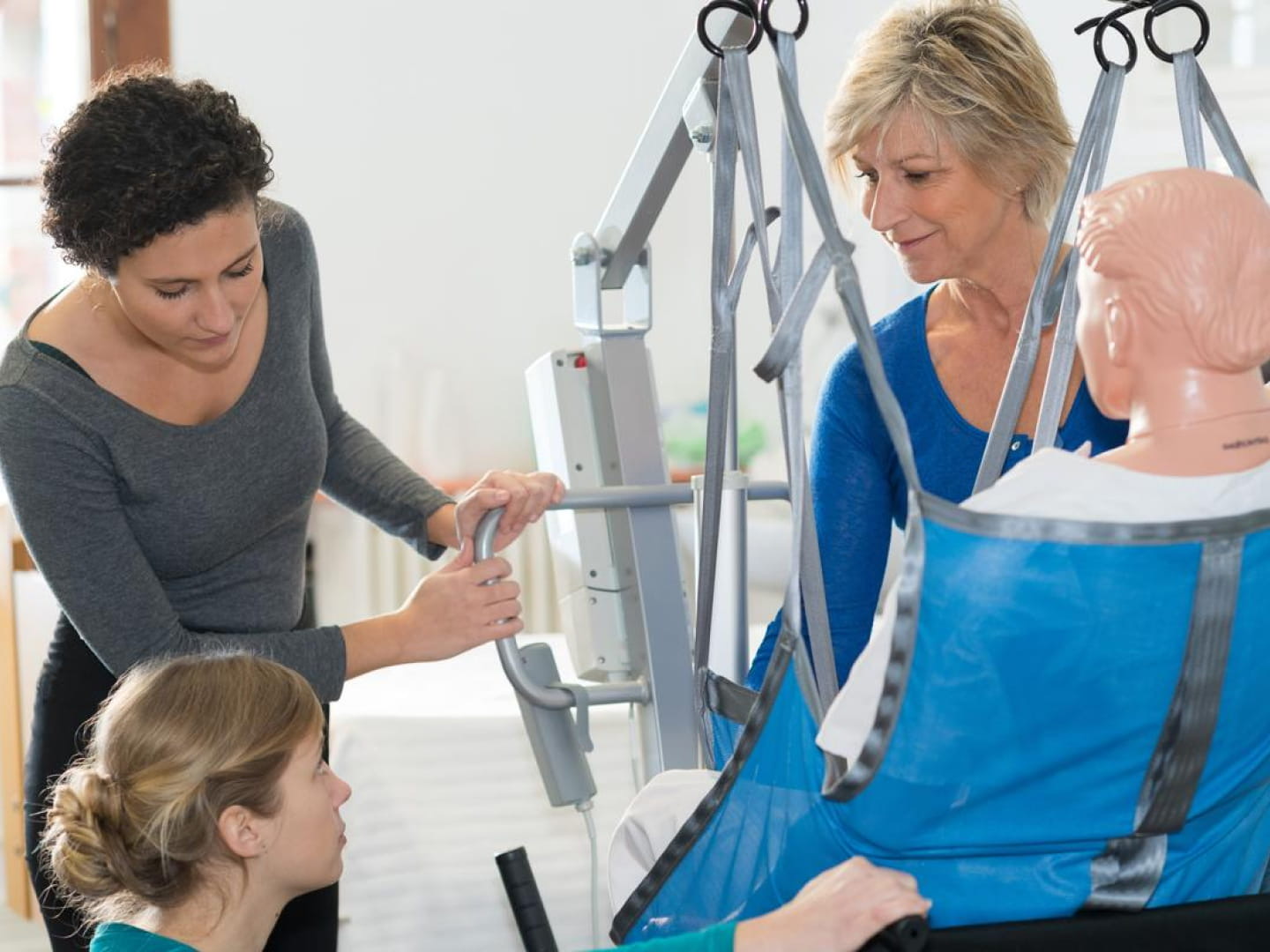 A support worker being trained on safe moving and handling